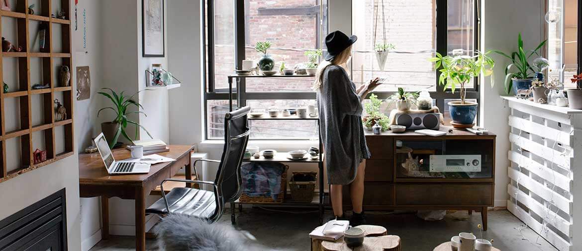 A young woman in her apartment on her cell phone